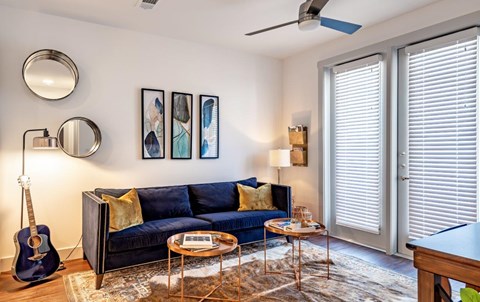 a living room with a couch and a guitar